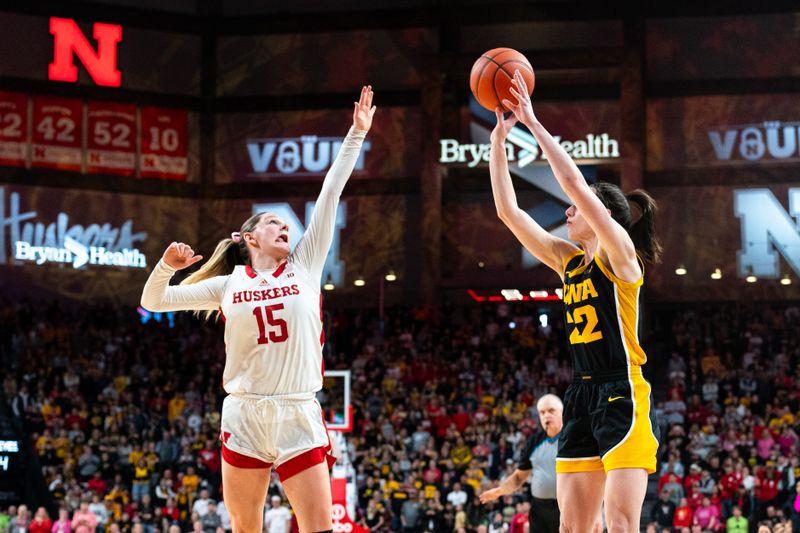 Feb 11, 2024; Lincoln, Nebraska, USA; Iowa Hawkeyes guard Caitlin Clark (22) shoots a three point shot against Nebraska Cornhuskers guard Kendall Moriarty (15) during the fourth quarter at Pinnacle Bank Arena. Mandatory Credit: Dylan Widger-USA TODAY Sports