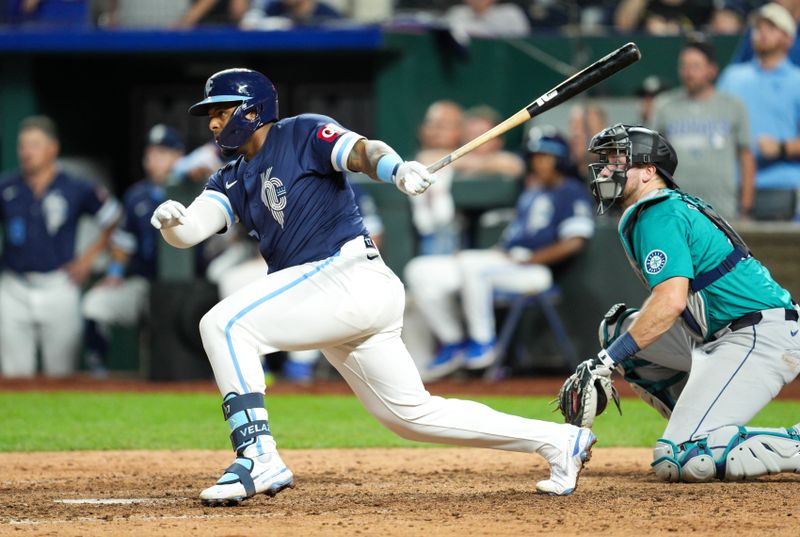 Jun 7, 2024; Kansas City, Missouri, USA; Kansas City Royals designated hitter Nelson Velazquez (17) hits into a fielder’s choice to score the winning run against the Seattle Mariners during the ninth inning at Kauffman Stadium. Mandatory Credit: Jay Biggerstaff-USA TODAY Sports