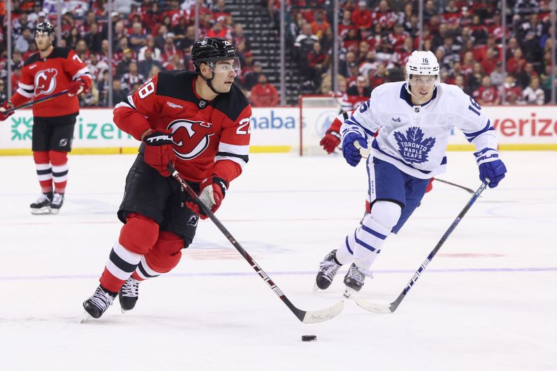 Oct 10, 2024; Newark, New Jersey, USA; New Jersey Devils right wing Timo Meier (28) skates with the puck while being defended by Toronto Maple Leafs right wing Mitch Marner (16) during the second period at Prudential Center. Mandatory Credit: Ed Mulholland-Imagn Images