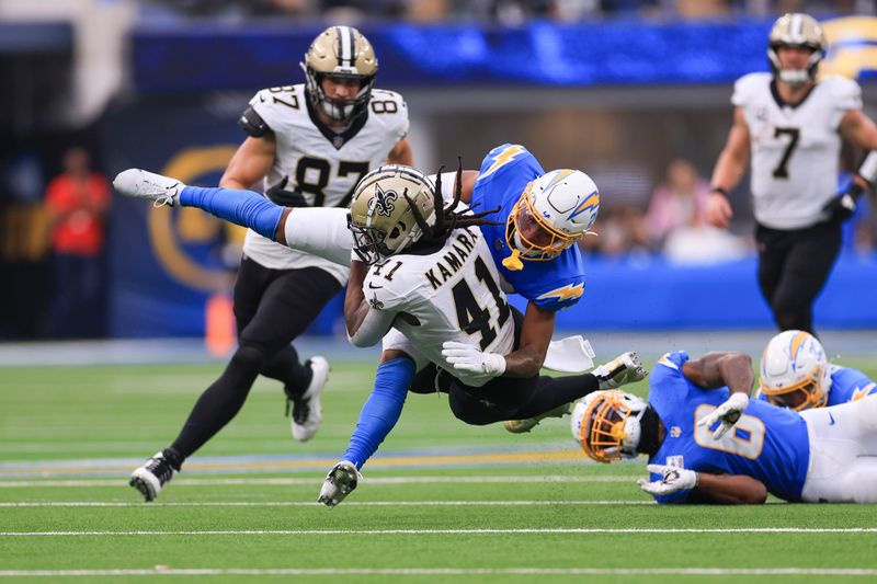 New Orleans Saints running back Alvin Kamara (41) is tackled by Los Angeles Chargers cornerback Tarheeb Still in the second half of an NFL football game in Inglewood, Calif., Sunday, Oct. 27, 2024. (AP Photo/Ryan Sun)
