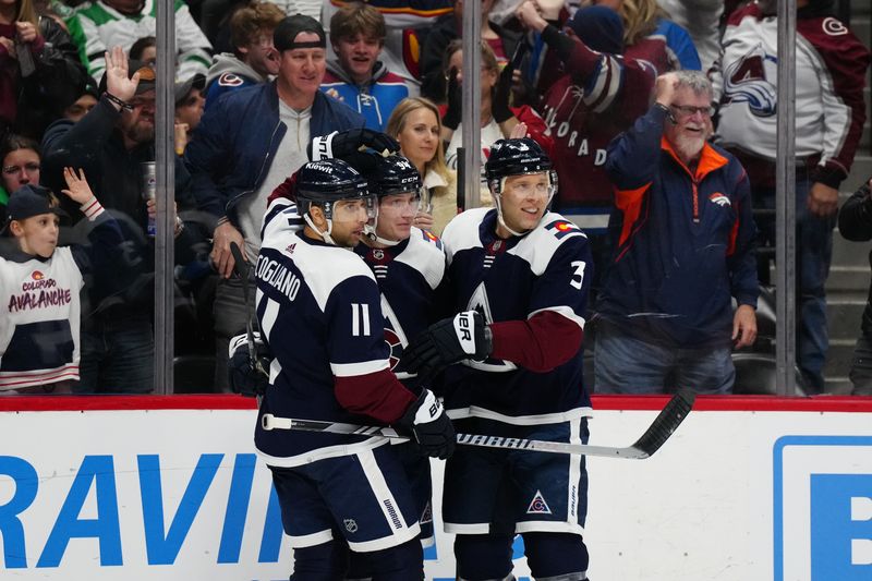 Feb 27, 2024; Denver, Colorado, USA; Colorado Avalanche center Andrew Cogliano (11) celebrates his goal with left wing Joel Kiviranta (94) and defenseman Jack Johnson (3) in the second period against the Dallas Stars at Ball Arena. Mandatory Credit: Ron Chenoy-USA TODAY Sports