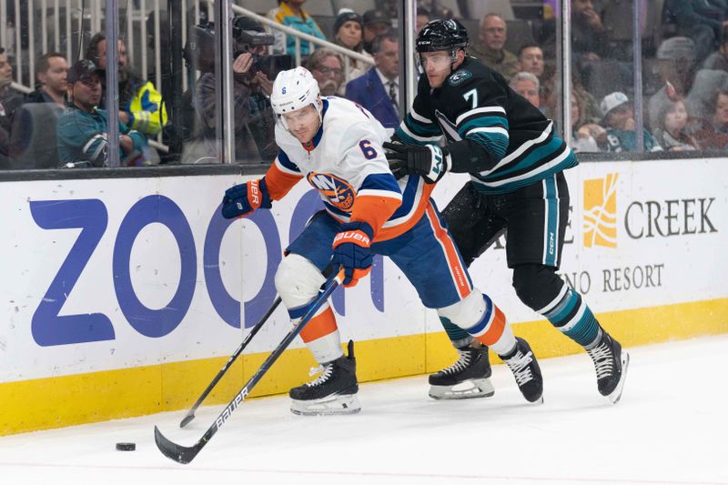 Mar 7, 2024; San Jose, California, USA; New York Islanders defenseman Ryan Pulock (6) and San Jose Sharks center Nico Sturm (7) fight for control of the puck during the second period at SAP Center at San Jose. Mandatory Credit: Stan Szeto-USA TODAY Sports