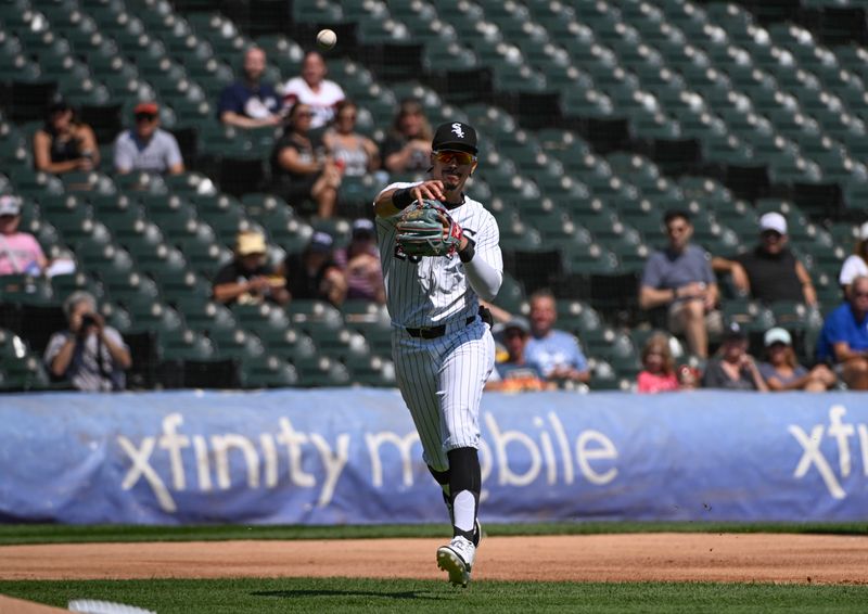 Aug 29, 2024; Chicago, Illinois, USA;   Chicago White Sox third baseman Miguel Vargas (20) throws to first base  to get out Texas Rangers outfielder Adolis GarcÌa (53) during the second inning at Guaranteed Rate Field. Mandatory Credit: Matt Marton-USA TODAY Sports