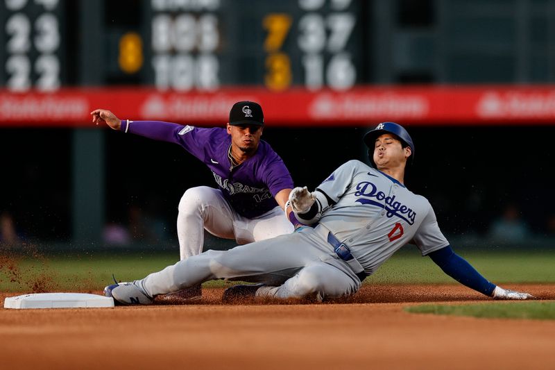 Jun 17, 2024; Denver, Colorado, USA; Los Angeles Dodgers designated hitter Shohei Ohtani (17) slides safely into second ahead of Colorado Rockies shortstop Ezequiel Tovar (14) on a double in the fourth inning at Coors Field. Mandatory Credit: Isaiah J. Downing-USA TODAY Sports