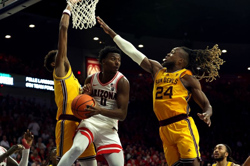 Feb 17, 2024; Tucson, Arizona, USA; Arizona Wildcats guard Jaden Bradley (0) makes a pass against Arizona State Sun Devils forward Bryant Selebangue (24) during the second half at McKale Center. Mandatory Credit: Zachary BonDurant-USA TODAY Sports