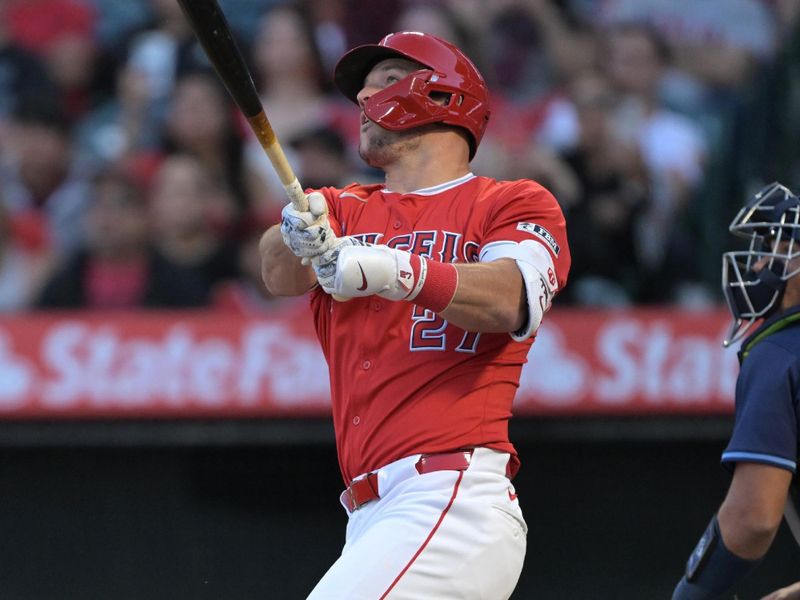 Apr 9, 2024; Anaheim, California, USA;  Los Angeles Angels outfielder Mike Trout (27) hits a two run home run in the first inning against the Tampa Bay Rays at Angel Stadium. Mandatory Credit: Jayne Kamin-Oncea-USA TODAY Sports