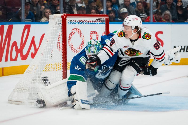Nov 5, 2025; Vancouver, British Columbia, CAN; Chicago Blackhawks forward Connor Bedard (98) collides with Vancouver Canucks goalie Kevin Lankinen (32) in the first period at Rogers Arena. Mandatory Credit: Bob Frid-Imagn Images