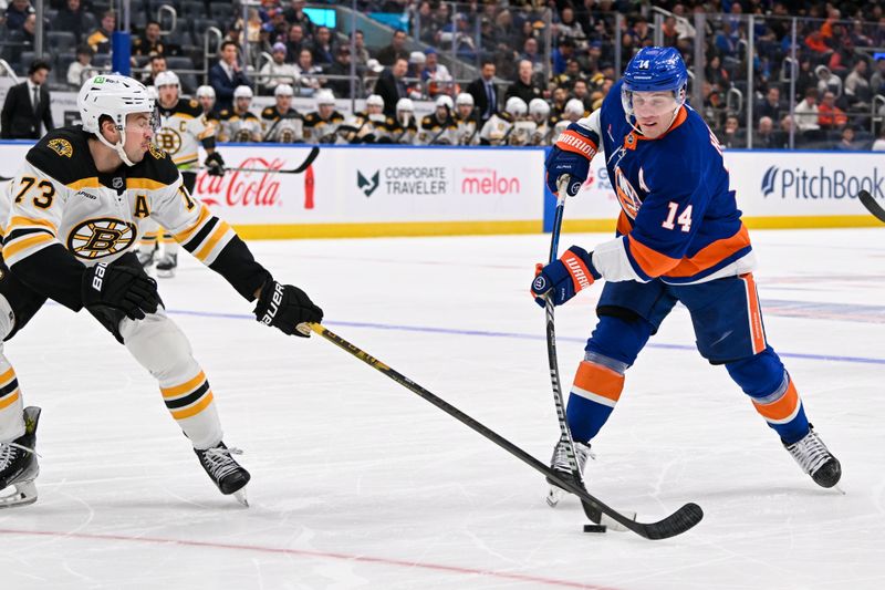 Nov 27, 2024; Elmont, New York, USA;  New York Islanders center Bo Horvat (14) attempts a shot defended by Boston Bruins defenseman Charlie McAvoy (73) during the second period at UBS Arena. Mandatory Credit: Dennis Schneidler-Imagn Images