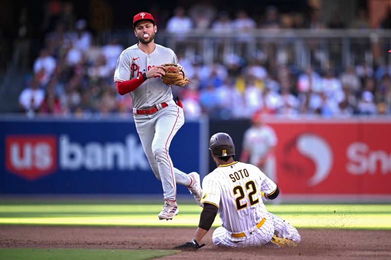 Sep 4, 2023; San Diego, California, USA; Philadelphia Phillies shortstop Trea Turner (top) forces out San Diego Padres left fielder Juan Soto (22) at second base during the third inning at Petco Park. Mandatory Credit: Orlando Ramirez-USA TODAY Sports