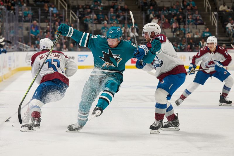 Oct 20, 2024; San Jose, California, USA; San Jose Sharks center Mikael Granlund (64) loses his balance as he forchecks against Colorado Avalanche center Casey Mittelstadt (37) and right wing Nikolai Kovalenko (51) during the first period at SAP Center at San Jose. Mandatory Credit: Robert Edwards-Imagn Images