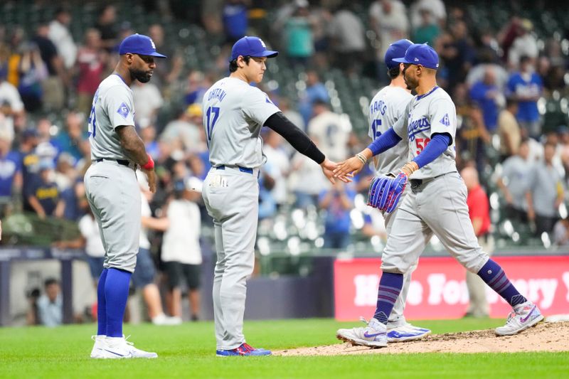 Aug 13, 2024; Milwaukee, Wisconsin, USA;  Los Angeles Dodgers shortstop Mookie Betts (50) is greeted by designated hitter Shohei Ohtani (17) following the game against the Milwaukee Brewers at American Family Field. Mandatory Credit: Jeff Hanisch-USA TODAY Sports