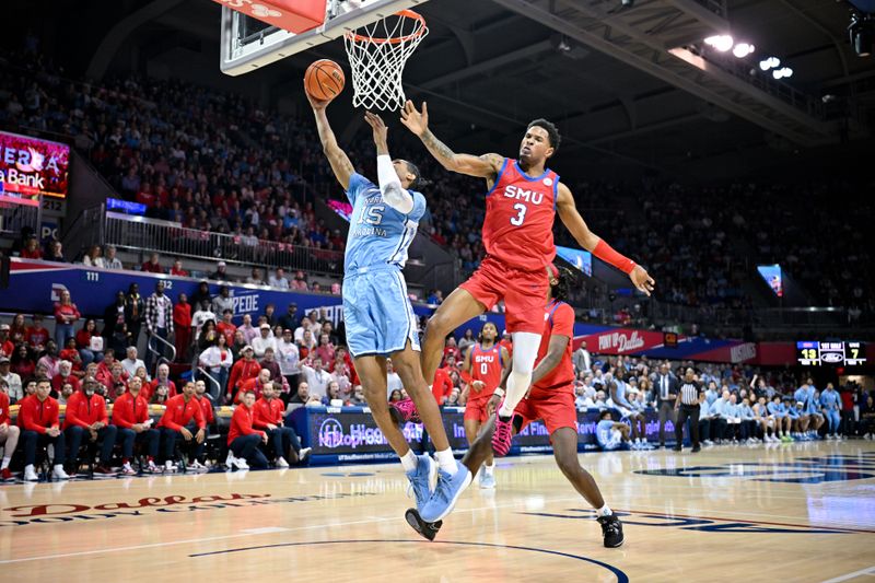 Jan 3, 2026; Dallas, Texas, USA; North Carolina Tar Heels forward Jarin Stevenson (15) drives to the basket past SMU Mustangs forward Corey Washington (3) during the first half at Moody Coliseum. Mandatory Credit: Jerome Miron-Imagn Images
