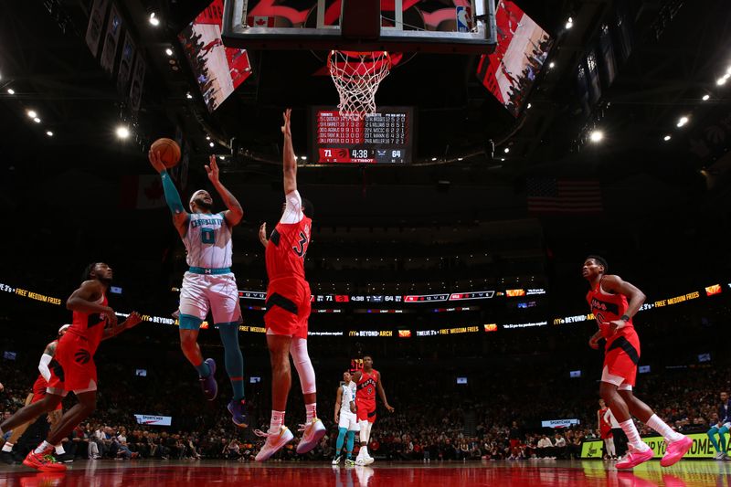 TORONTO, CANADA - MARCH 3: Miles Bridges #0 of the Charlotte Hornets drives to the basket during the game against the Toronto Raptors on March 3, 2024 at the Scotiabank Arena in Toronto, Ontario, Canada.  NOTE TO USER: User expressly acknowledges and agrees that, by downloading and or using this Photograph, user is consenting to the terms and conditions of the Getty Images License Agreement.  Mandatory Copyright Notice: Copyright 2024 NBAE (Photo by Vaughn Ridley/NBAE via Getty Images)