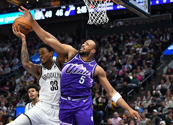 SALT LAKE CITY, UTAH - DECEMBER 18: Nic Claxton #33 of the Brooklyn Nets rebounds over Talen Horton-Tucker #5 of the Utah Jazz during the first half of a game at Delta Center on December 18, 2023 in Salt Lake City, Utah. NOTE TO USER: User expressly acknowledges and agrees that, by downloading and or using this photograph, User is consenting to the terms and conditions of the Getty Images License Agreement. (Photo by Alex Goodlett/Getty Images)