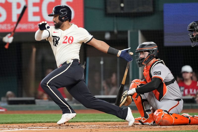 Jun 7, 2024; Arlington, Texas, USA; Texas Rangers third baseman Ezequiel Duran follows through on his single against the San Francisco Giants during the third inning at Globe Life Field. Mandatory Credit: Jim Cowsert-USA TODAY Sports