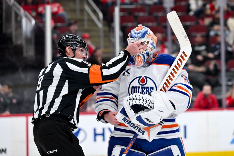 Oct 18, 2025; Newark, New Jersey, USA; Edmonton Oilers goaltender Calvin Pickard (30) receives assistance with his mask from a referee during the second period against the New Jersey Devils at Prudential Center. Mandatory Credit: John Jones-Imagn Images