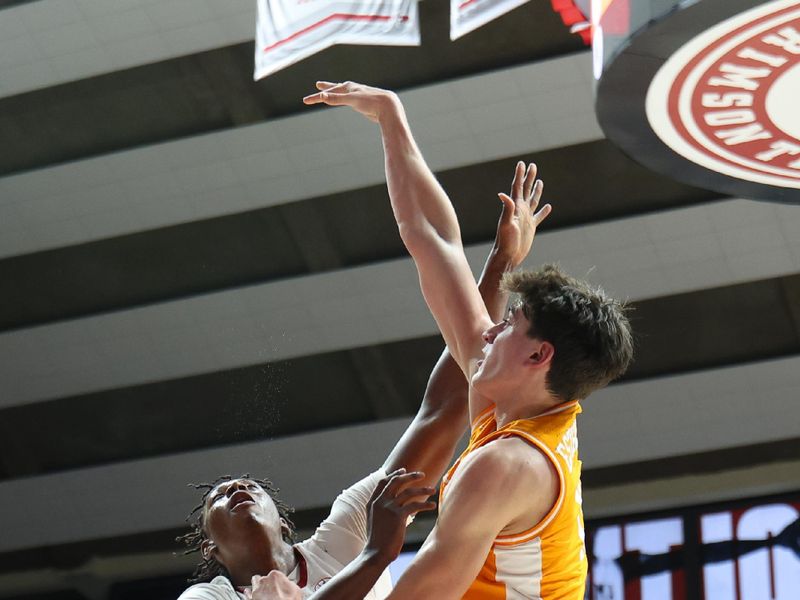 Jan 24, 2026; Tuscaloosa, Alabama, USA; Tennessee Volunteers forward J.P. Estrella (13) shoots over Alabama Crimson Tide forward Aiden Sherrell (22) during the first half at Coleman Coliseum. Mandatory Credit: David Leong-Imagn Images