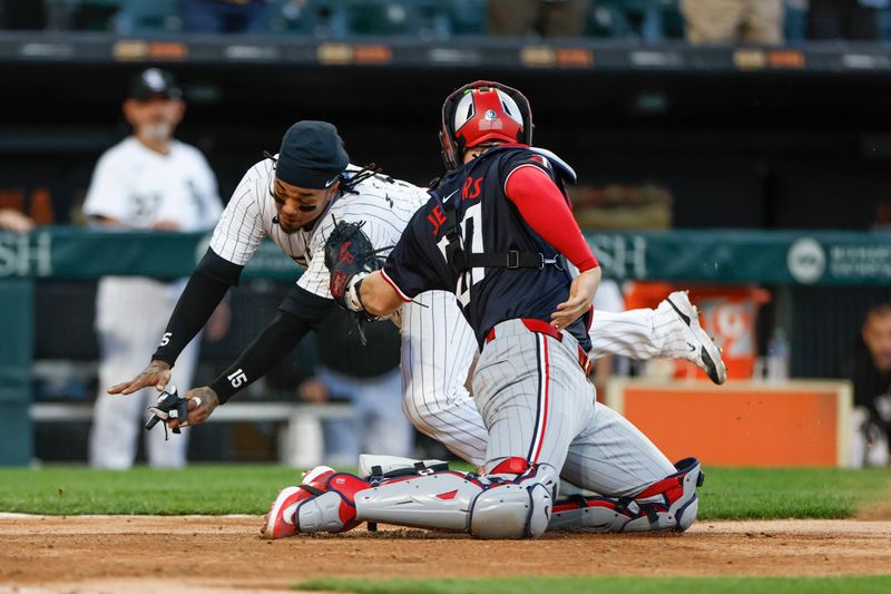 Apr 30, 2024; Chicago, Illinois, USA; Chicago White Sox catcher Martín Maldonado (15) slides to score but is tagged out by Minnesota Twins catcher Ryan Jeffers (27) at home plate during the third inning at Guaranteed Rate Field. Mandatory Credit: Kamil Krzaczynski-USA TODAY Sports