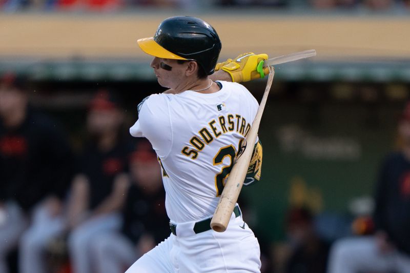 Jul 5, 2024; Oakland, California, USA;  Oakland Athletics first base Tyler Soderstrom (21) breaks his bat during the first inning against the Baltimore Orioles at Oakland-Alameda County Coliseum. Mandatory Credit: Stan Szeto-USA TODAY Sports