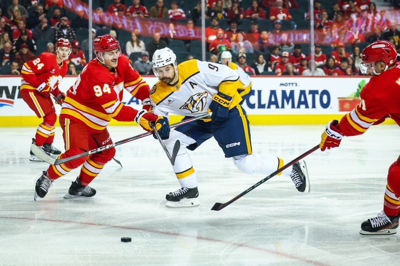 Nov 15, 2024; Calgary, Alberta, CAN; Nashville Predators left wing Filip Forsberg (9) and Calgary Flames defenseman Brayden Pachal (94) battles for the puck during the first period at Scotiabank Saddledome. Mandatory Credit: Sergei Belski-Imagn Images