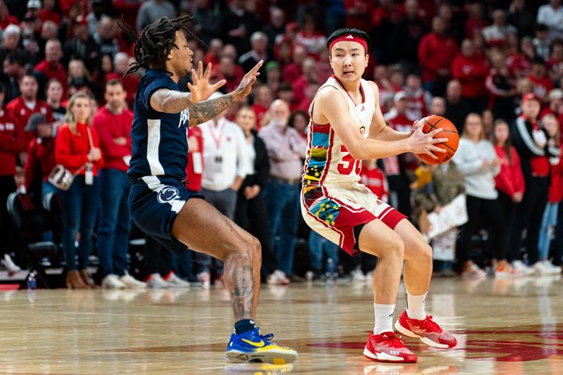 Feb 17, 2024; Lincoln, Nebraska, USA; Nebraska Cornhuskers guard Keisei Tominaga (30) looks to pass against Penn State Nittany Lions guard Ace Baldwin Jr. (1) during the first half at Pinnacle Bank Arena. Mandatory Credit: Dylan Widger-USA TODAY Sports