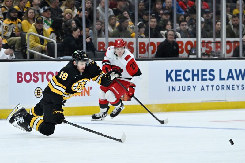 Nov 1, 2025; Boston, Massachusetts, USA; Boston Bruins center John Beecher (19) loses his edge skating to the puck during the third period against the Carolina Hurricanes at TD Garden. Mandatory Credit: Eric Canha-Imagn Images