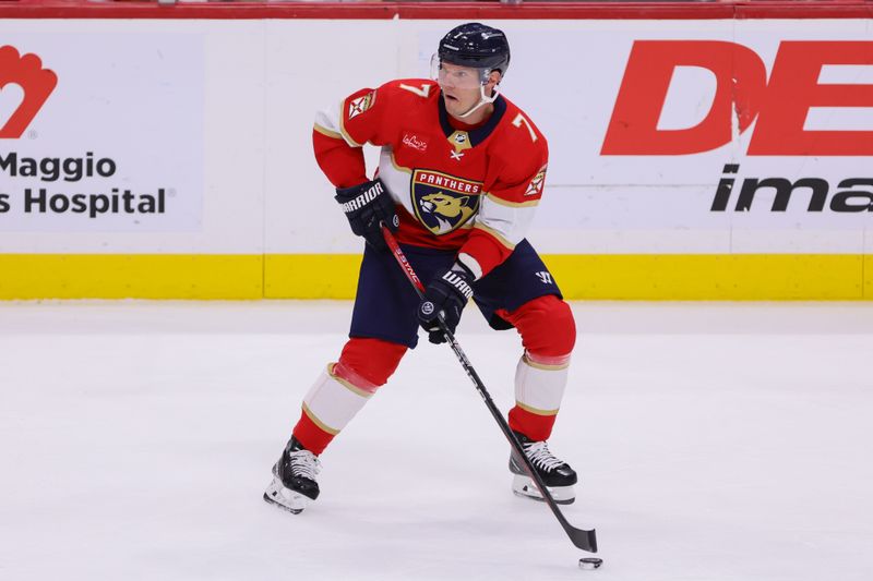 Apr 9, 2024; Sunrise, Florida, USA; Florida Panthers defenseman Dmitry Kulikov (7) moves the puck against the Ottawa Senators during the third period at Amerant Bank Arena. Mandatory Credit: Sam Navarro-USA TODAY Sports