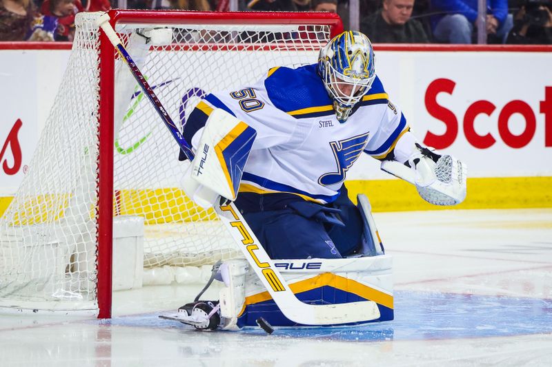 Jan 23, 2024; Calgary, Alberta, CAN; St. Louis Blues goaltender Jordan Binnington (50) makes a save against the Calgary Flames during the second period at Scotiabank Saddledome. Mandatory Credit: Sergei Belski-USA TODAY Sports