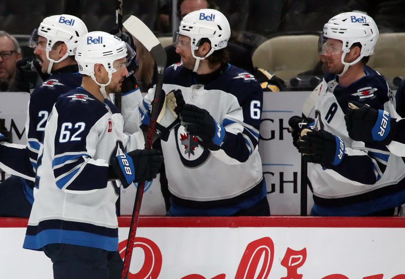 Nov 22, 2024; Pittsburgh, Pennsylvania, USA;  Winnipeg Jets right wing Nino Niederreiter (62) celebrates his goal with the Jets bench against the Pittsburgh Penguins during the first period at PPG Paints Arena. Mandatory Credit: Charles LeClaire-Imagn Images