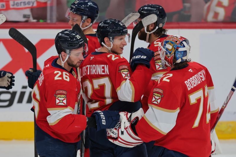 Mar 1, 2025; Sunrise, Florida, USA; Florida Panthers goaltender Sergei Bobrovsky (72) celebrates with defenseman Uvis Balinskis (26) and center Eetu Luostarinen (27) after the game against the Calgary Flames at Amerant Bank Arena. Mandatory Credit: Sam Navarro-Imagn Images