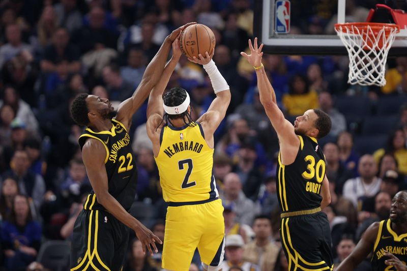 SAN FRANCISCO, CALIFORNIA - MARCH 22: Andrew Wiggins #22 of the Golden State Warriors blocks a shot taken by Andrew Nembhard #2 of the Indiana Pacers as Stephen Curry #30 of the Golden State Warriors also goes up to defend in the first half at Chase Center on March 22, 2024 in San Francisco, California. NOTE TO USER: User expressly acknowledges and agrees that, by downloading and or using this photograph, User is consenting to the terms and conditions of the Getty Images License Agreement.  (Photo by Ezra Shaw/Getty Images)