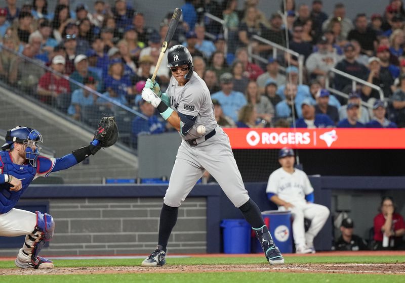 Jun 30, 2024; Toronto, Ontario, CAN; New York Yankees designated hitter Aaron Judge (99) gets hit with a pitch against the Toronto Blue Jays during the fourth inning at Rogers Centre. Mandatory Credit: Nick Turchiaro-USA TODAY Sports