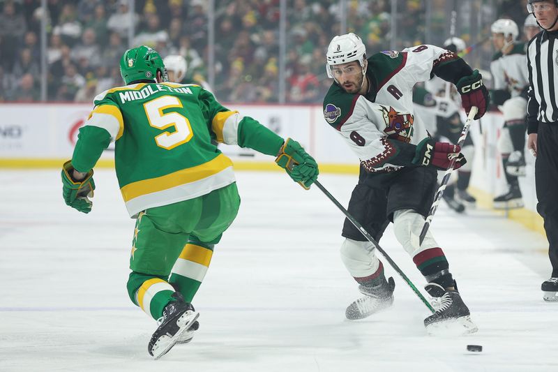 Jan 13, 2024; Saint Paul, Minnesota, USA; Arizona Coyotes center Nick Schmaltz (8) passes as Minnesota Wild defenseman Jake Middleton (5) defends during the first period at Xcel Energy Center. Mandatory Credit: Matt Krohn-USA TODAY Sports