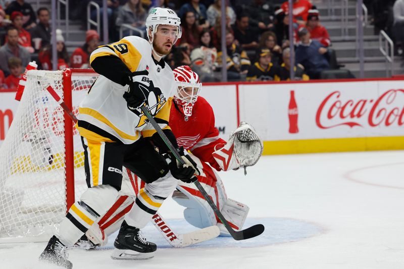 Oct 18, 2023; Detroit, Michigan, USA; Pittsburgh Penguins right wing Reilly Smith (19) skates in front of Detroit Red Wings goaltender Ville Husso (35) in the first period at Little Caesars Arena. Mandatory Credit: Rick Osentoski-USA TODAY Sports