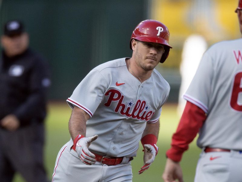 Jun 16, 2023; Oakland, California, USA; Philadelphia Phillies catcher J.T. Realmuto (10) celebrates with Philadelphia Phillies third base coach Dusty Wathan (62) after hitting a solo home run the second inning at Oakland-Alameda County Coliseum. Mandatory Credit: D. Ross Cameron-USA TODAY Sports