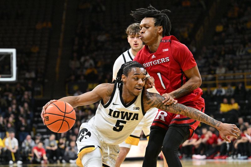 Jan 6, 2024; Iowa City, Iowa, USA; Iowa Hawkeyes guard Dasonte Bowen (5) controls the ball as Rutgers Scarlet Knights guard Jamichael Davis (1) defends during the second half at Carver-Hawkeye Arena. Mandatory Credit: Jeffrey Becker-USA TODAY Sports