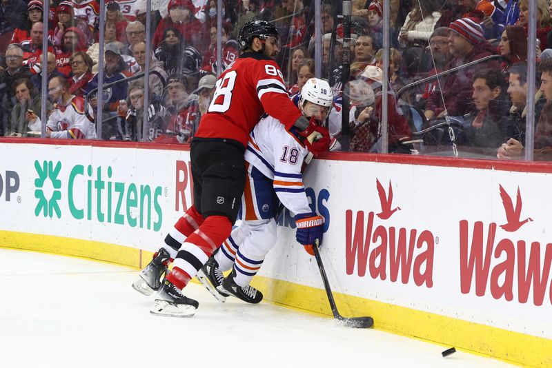 Dec 21, 2023; Newark, New Jersey, USA; New Jersey Devils defenseman Kevin Bahl (88) hits Edmonton Oilers left wing Zach Hyman (18) during the first period at Prudential Center. Mandatory Credit: Ed Mulholland-USA TODAY Sports