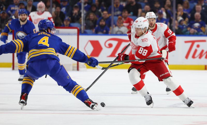 Mar 27, 2026; Buffalo, New York, USA;  Detroit Red Wings right wing Patrick Kane (88) tries to control the puck as Buffalo Sabres defenseman Bowen Byram (4) defends during the first period at KeyBank Center. Mandatory Credit: Timothy T. Ludwig-Imagn Images