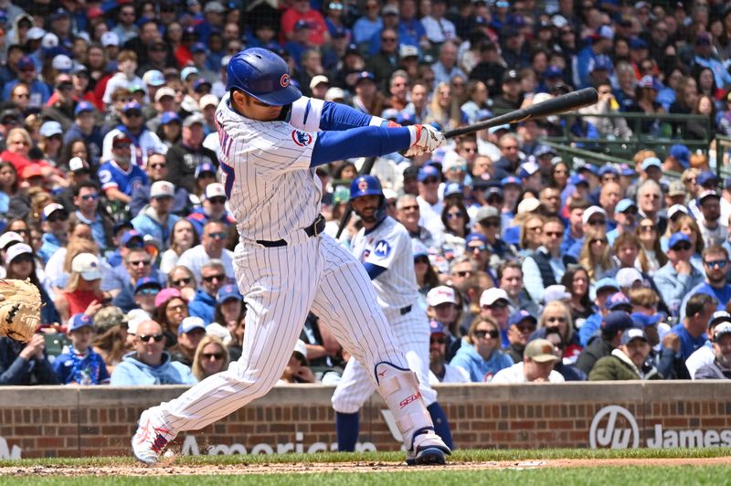 May 26, 2025; Chicago, Illinois, USA; Chicago Cubs designated hitter Seiya Suzuki (27) hits a double during the first inning against the Colorado Rockies at Wrigley Field. Mandatory Credit: Patrick Gorski-Imagn Images