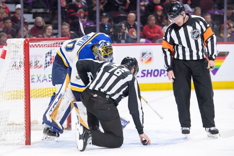 Mar 21, 2024; Ottawa, Ontario, CAN; NHL linesman Michel Cormier (76) fixes the ice in the crease in front of St. Louis Blues goalie Joel Hofer (30) in the first period against the Ottawa Senators at the Canadian Tire Centre. Mandatory Credit: Marc DesRosiers-USA TODAY Sports