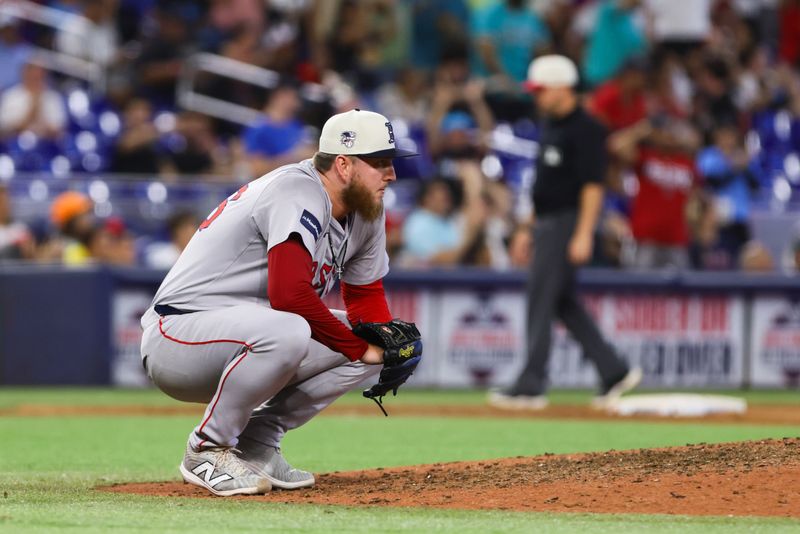 Jul 4, 2024; Miami, Florida, USA; Boston Red Sox relief pitcher Zack Kelly (76) reacts after allowing a two-run home run against Miami Marlins right fielder Jesus Sanchez (not pictured) during the eleventh inning at loanDepot Park. Mandatory Credit: Sam Navarro-USA TODAY Sports