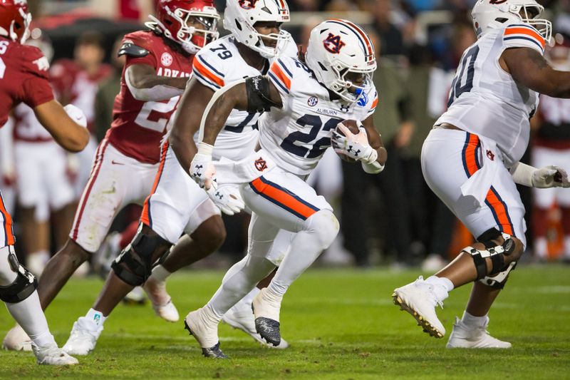 Nov 11, 2023; Fayetteville, Arkansas, USA;  Auburn Tigers running back Damari Alston (22) runs the ball during the fourth quarter against the Arkansas Razorbacks at Donald W. Reynolds Razorback Stadium. Mandatory Credit: Brett Rojo-USA TODAY Sports