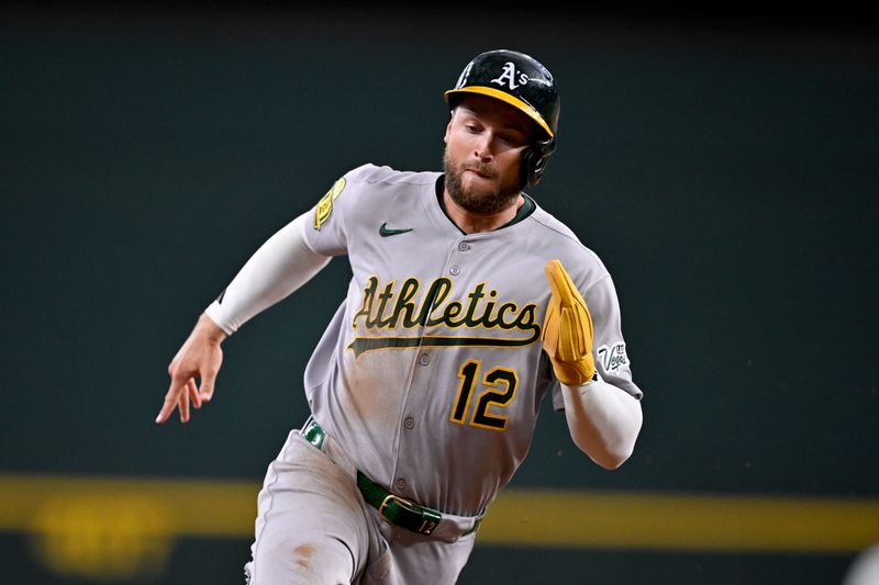 May 1, 2025; Arlington, Texas, USA; Athletics pinch runner Max Schuemann (12) scores against the Texas Rangers during the seventh inning at Globe Life Field. Mandatory Credit: Jerome Miron-Imagn Images