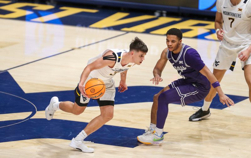 Mar 6, 2024; Morgantown, West Virginia, USA; West Virginia Mountaineers guard Kerr Kriisa (3) drives against TCU Horned Frogs guard Jameer Nelson Jr. (4) during the first half at WVU Coliseum. Mandatory Credit: Ben Queen-USA TODAY Sports