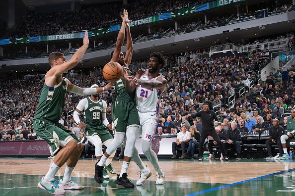 MILWAUKEE, WI - OCTOBER 26: Joel Embiid #21 of the Philadelphia 76ers passes the ball during the game against the Milwaukee Bucks on October 26, 2023 at the Fiserv Forum Center in Milwaukee, Wisconsin. NOTE TO USER: User expressly acknowledges and agrees that, by downloading and or using this Photograph, user is consenting to the terms and conditions of the Getty Images License Agreement. Mandatory Copyright Notice: Copyright 2023 NBAE (Photo by Jesse D. Garrabrant/NBAE via Getty Images).