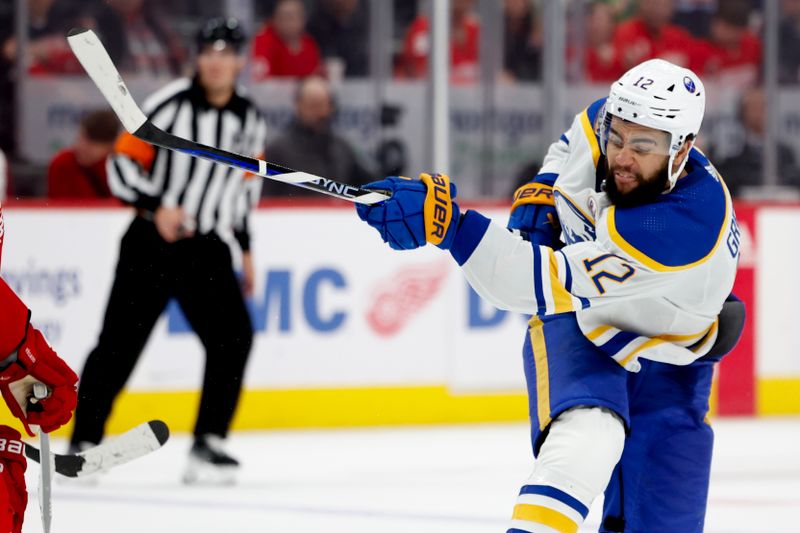 Mar 16, 2024; Detroit, Michigan, USA;  Buffalo Sabres left wing Jordan Greenway (12) takes a shot in the third period against the Detroit Red Wings at Little Caesars Arena. Mandatory Credit: Rick Osentoski-USA TODAY Sports