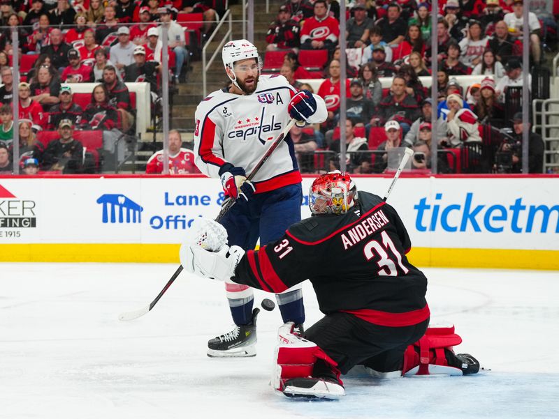 May 10, 2025; Raleigh, North Carolina, USA; Carolina Hurricanes goaltender Frederik Andersen (31) stops the shot next to Washington Capitals right wing Tom Wilson (43) during the second period in game three of the second round of the 2025 Stanley Cup Playoffs at Lenovo Center. Mandatory Credit: James Guillory-Imagn Images
