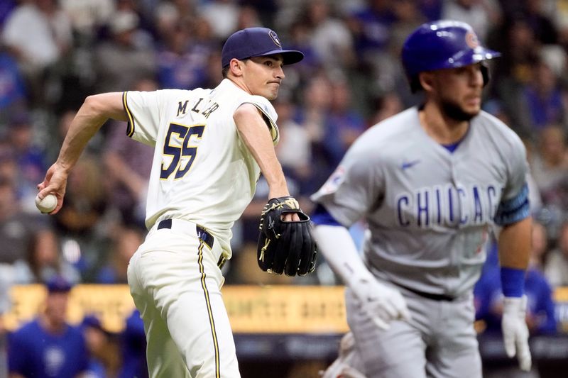 May 28, 2024; Milwaukee, Wisconsin, USA;  Milwaukee Brewers pitcher Hoby Milner (55) throws out Chicago Cubs third baseman Nick Madrigal (1) during the tenth inning at American Family Field. Mandatory Credit: Jeff Hanisch-USA TODAY Sports