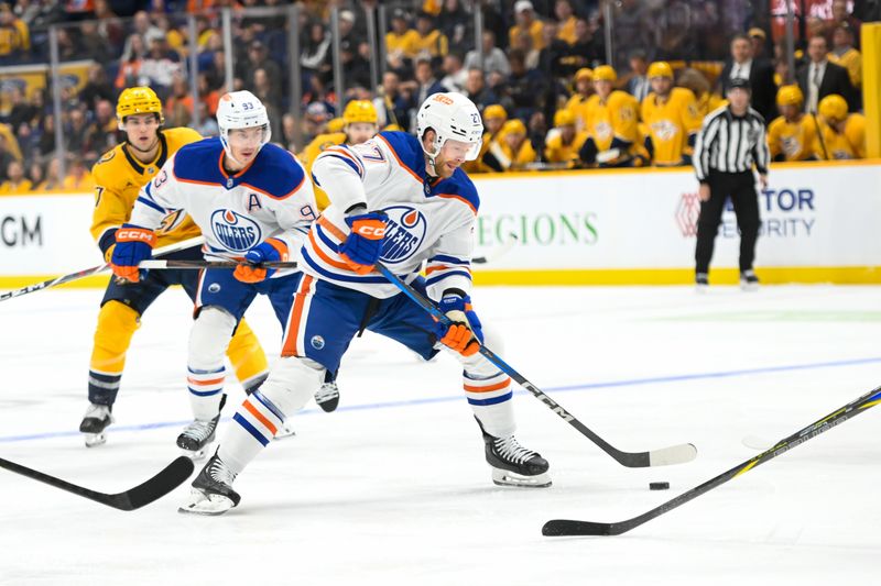 Oct 17, 2024; Nashville, Tennessee, USA;  Edmonton Oilers defenseman Brett Kulak (27) takes a shot on goal against the Nashville Predators during the second period at Bridgestone Arena. Mandatory Credit: Steve Roberts-Imagn Images