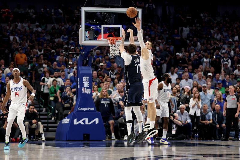 DALLAS, TEXAS - APRIL 28: Luka Doncic #77 of the Dallas Mavericks takes a three-point shot while defended by Ivica Zubac #40 of the Los Angeles Clippers in the second half of game four of the Western Conference First Round Playoffs at American Airlines Center on April 28, 2024 in Dallas, Texas.  NOTE TO USER: User expressly acknowledges and agrees that, by downloading and or using this photograph, User is consenting to the terms and conditions of the Getty Images License Agreement. (Photo by Tim Warner/Getty Images)